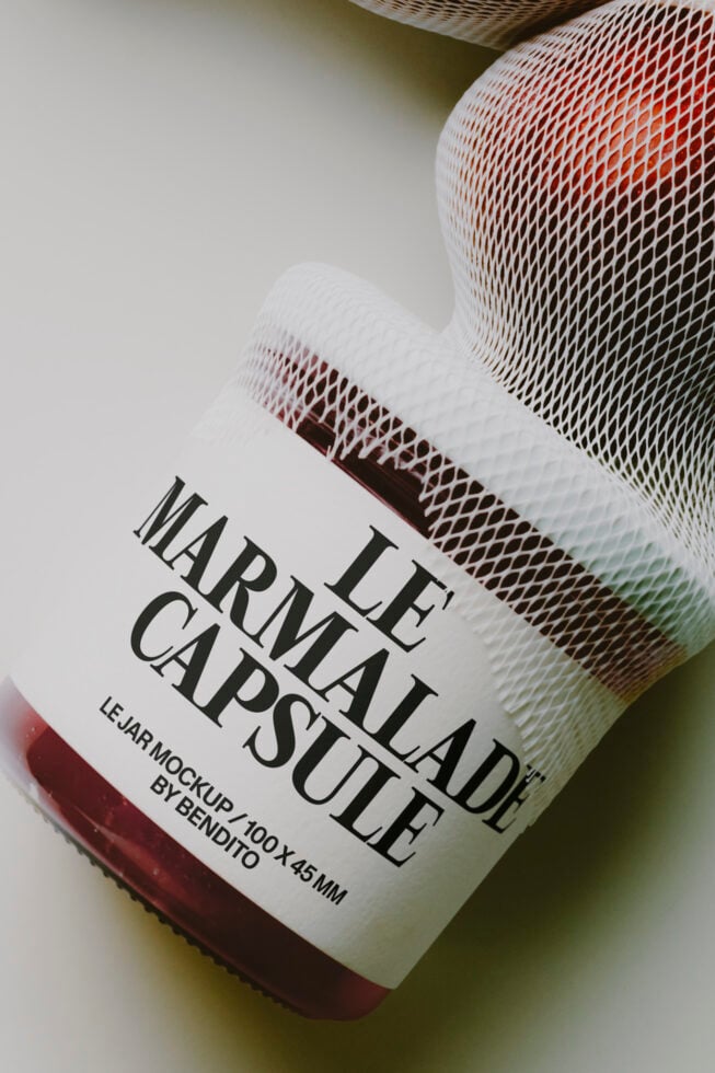 Glass jar mockup with mesh fabric overlay, red liquid inside, serif label mockup