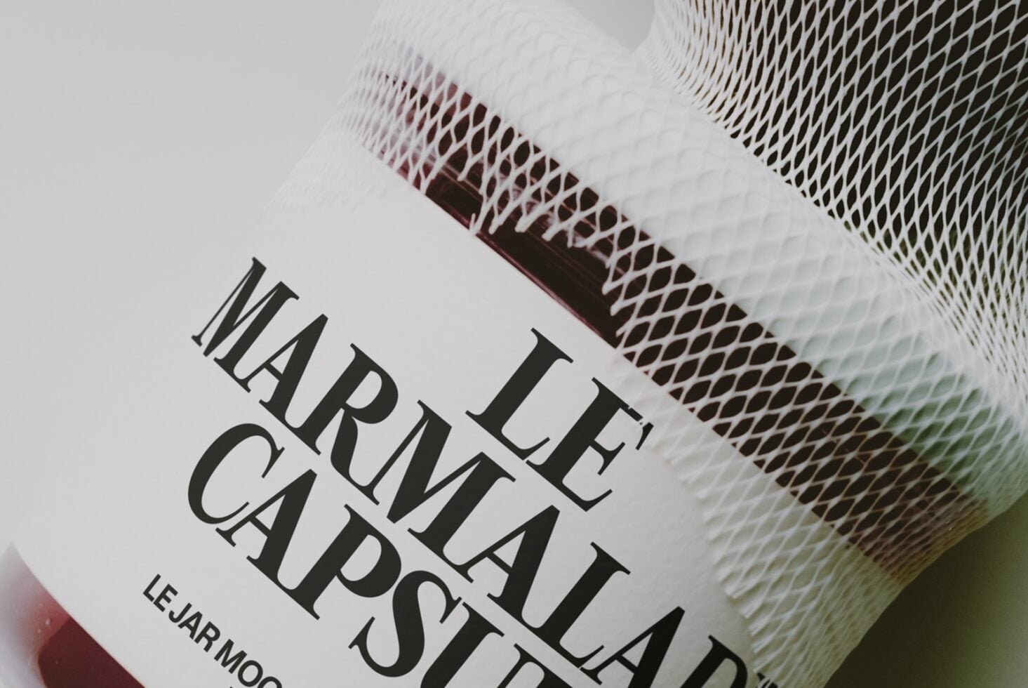 Closeup of textured jar label with serif typography reading "LE FLAT CAPASAT" on cream background