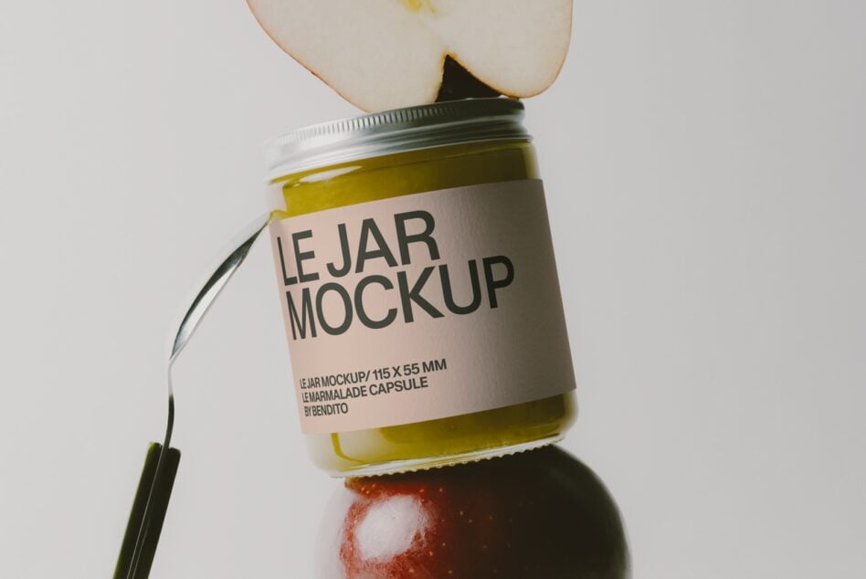 Glass jar with olive oil, apple slice, tomato, spoon showing jam or preserve packaging mockup