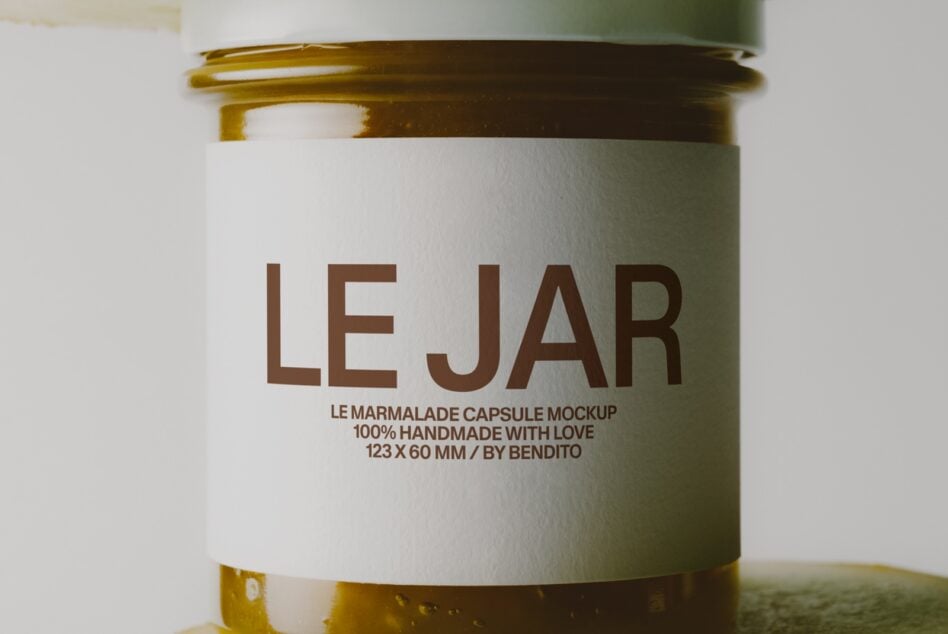 Glass jar mockup with sage green lid, brown text reading "LE JAR" on cream label, marmalade capsule design by Bendito
