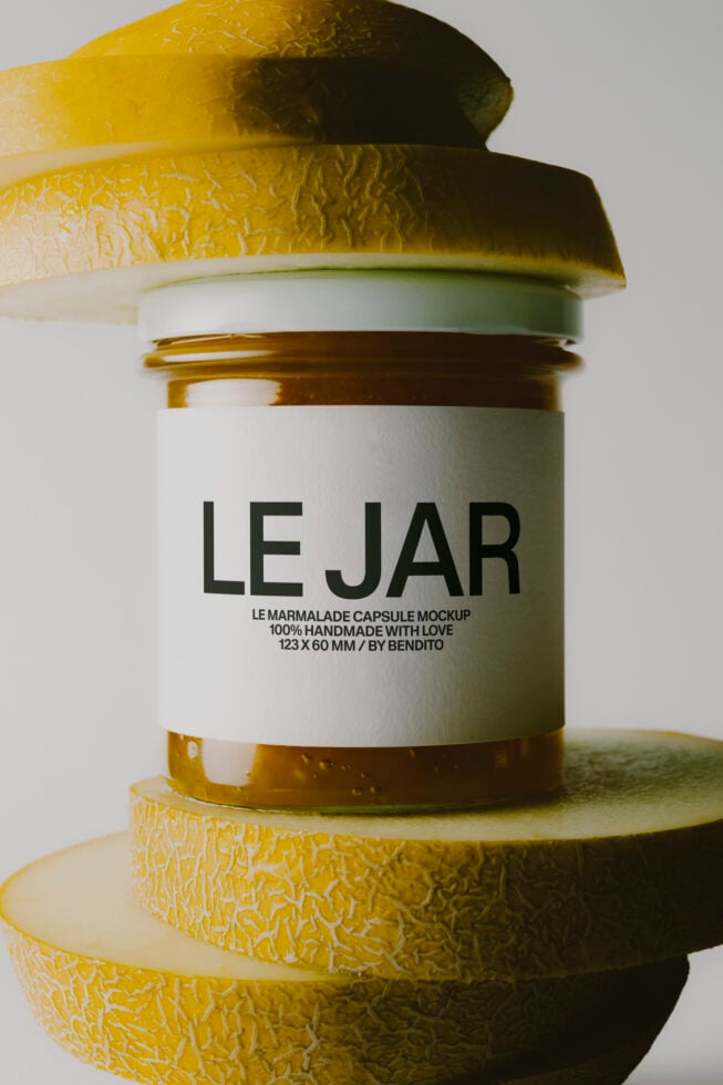 Jam jar mockup with gold foil capsule lid stacked on fresh lemons
