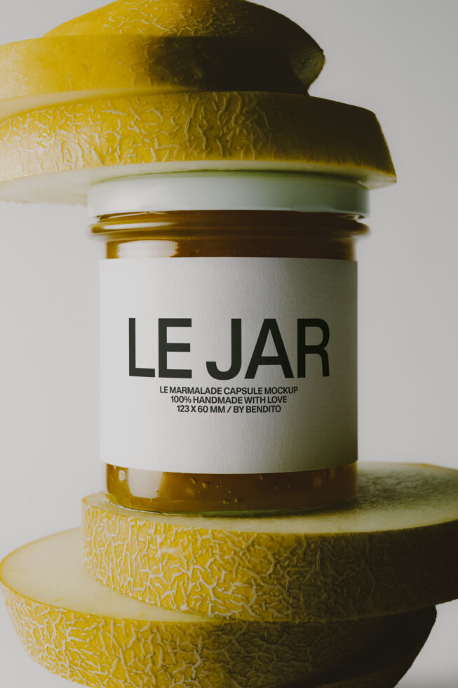 Jam jar mockup with gold foil cap surrounded by fresh lemon slices on white background