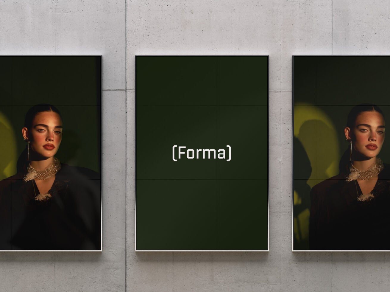 Three framed portraits on concrete wall with moody lighting, center frame editable