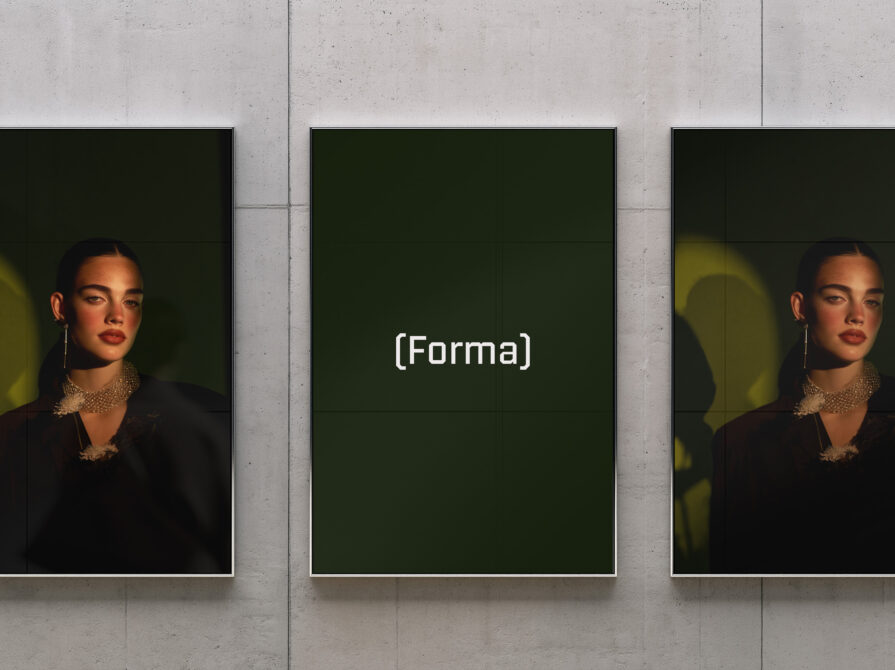 Three framed portraits on concrete wall with moody lighting, center frame editable
