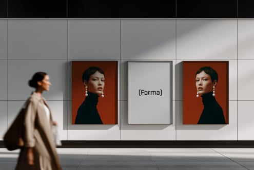 Gallery wall mockup with framed portrait on burnt orange, blank frame, woman walking by in modern storefront setting