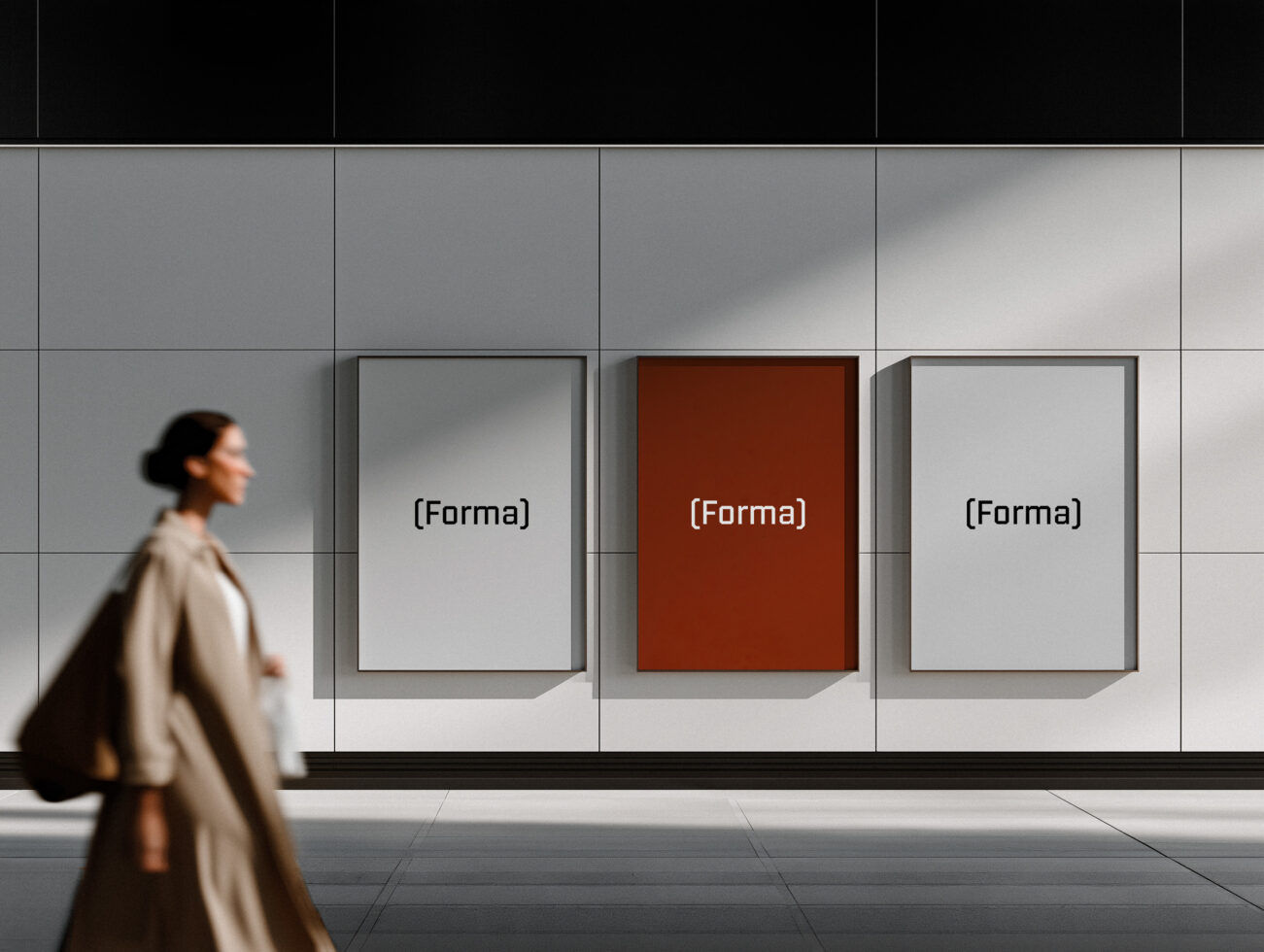 Woman walking past three framed posters on gallery wall, middle one rust colored