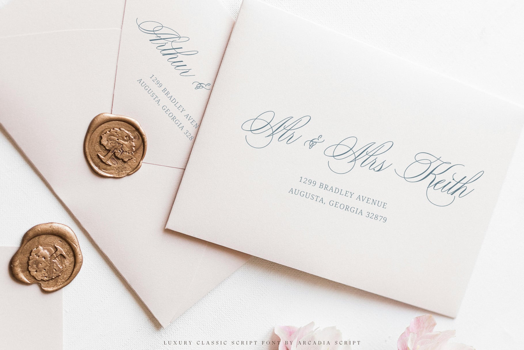 Elegant wedding stationery with script calligraphy, gold wax seals, pastel envelopes
