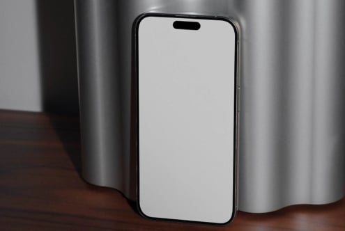 iPhone mockup with blank screen on wooden table, metallic backdrop