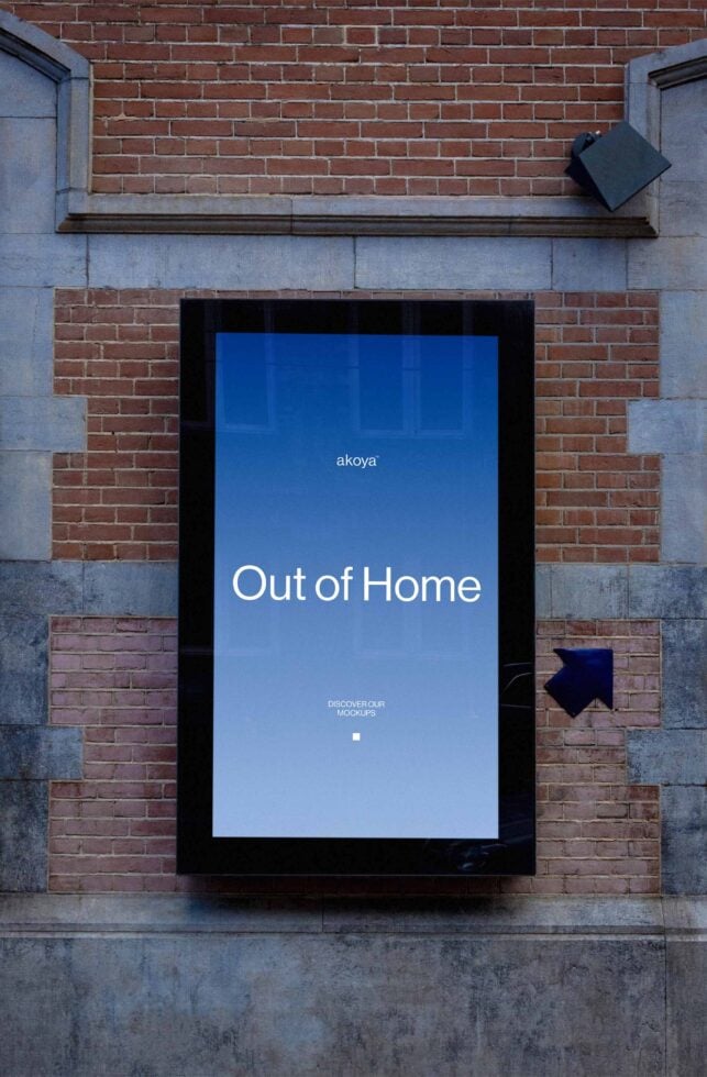 Digital billboard on brick wall displaying blue screen with "Out of Home" text