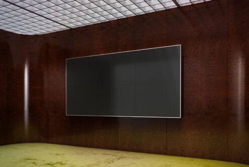 Modern gallery space with dark wood walls, grid ceiling, neon screen mockup on display