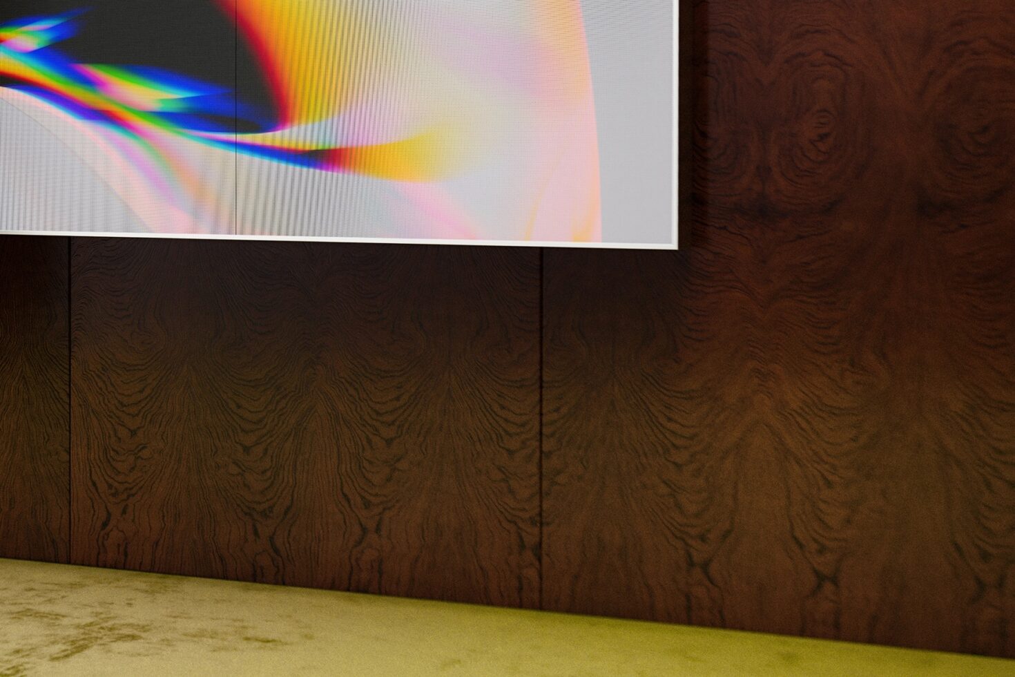 Rainbow light prism on gallery screen above dark wood wall with concrete floor
