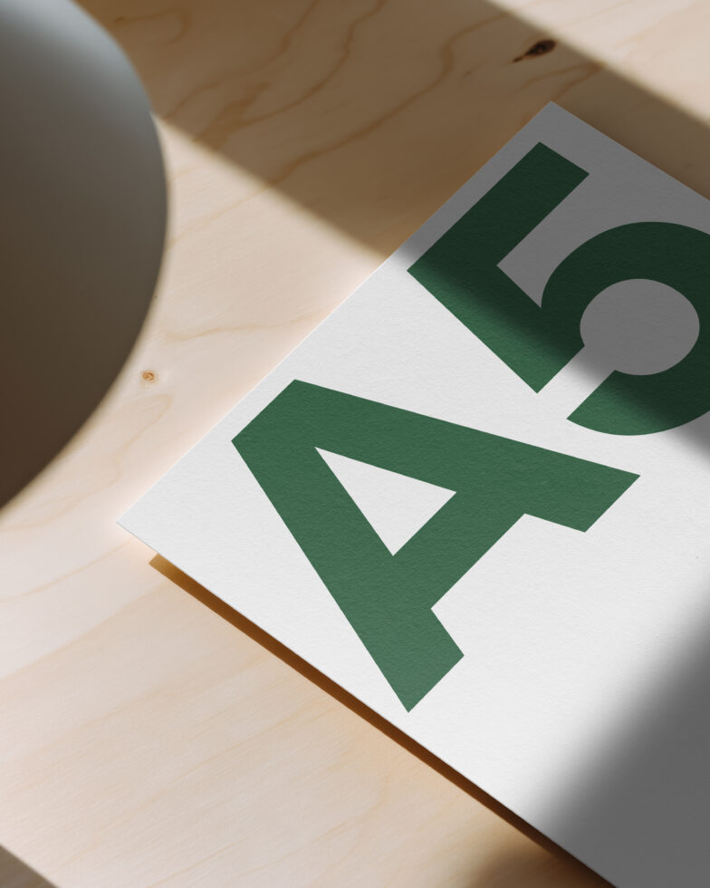 Card mockup with bold green arrow cursor design on natural wood background
