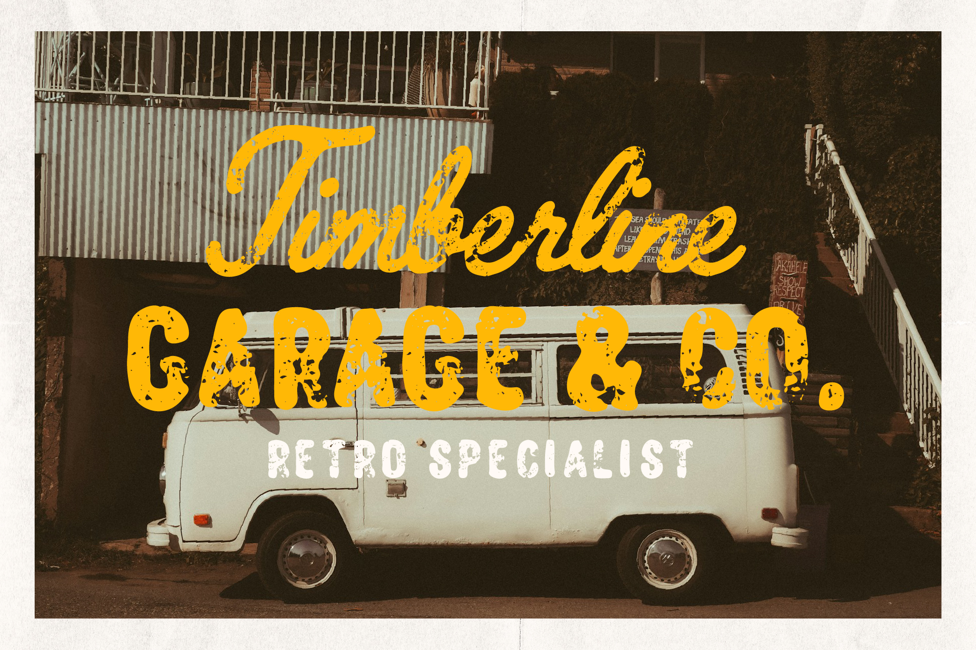 Vintage garage sign with distressed yellow lettering on weathered metal wall behind cream-colored van with retro vibes
