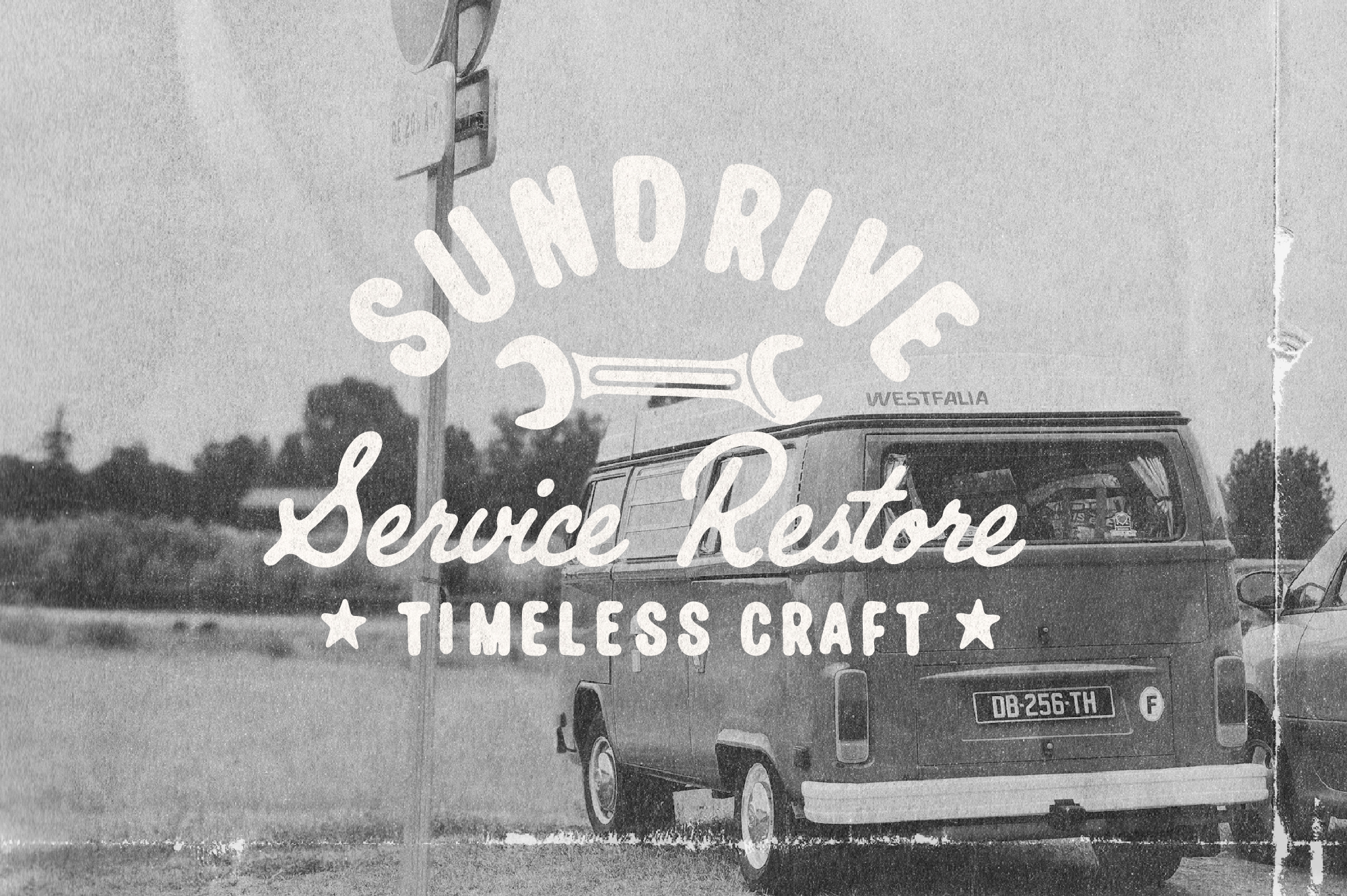 Retro black-and-white photo of vintage van with hand-drawn service station signage overlay