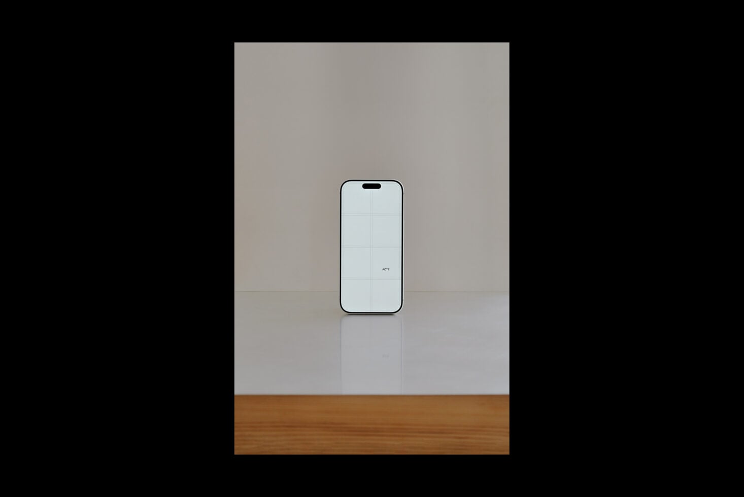 iPhone mockup standing on wooden base with minimal grey backdrop