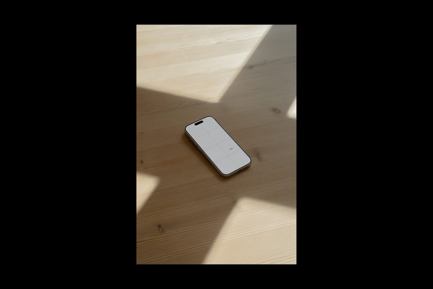 iPhone mockup on light wood table with natural window shadows