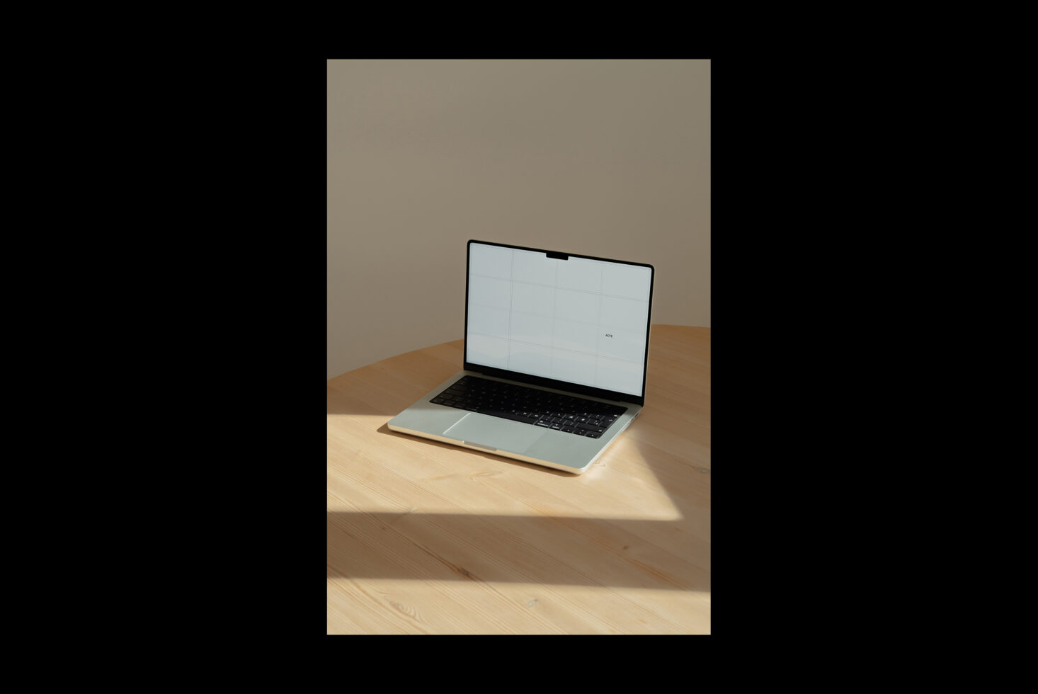 Open laptop mockup on wooden desk with minimal beige wall background