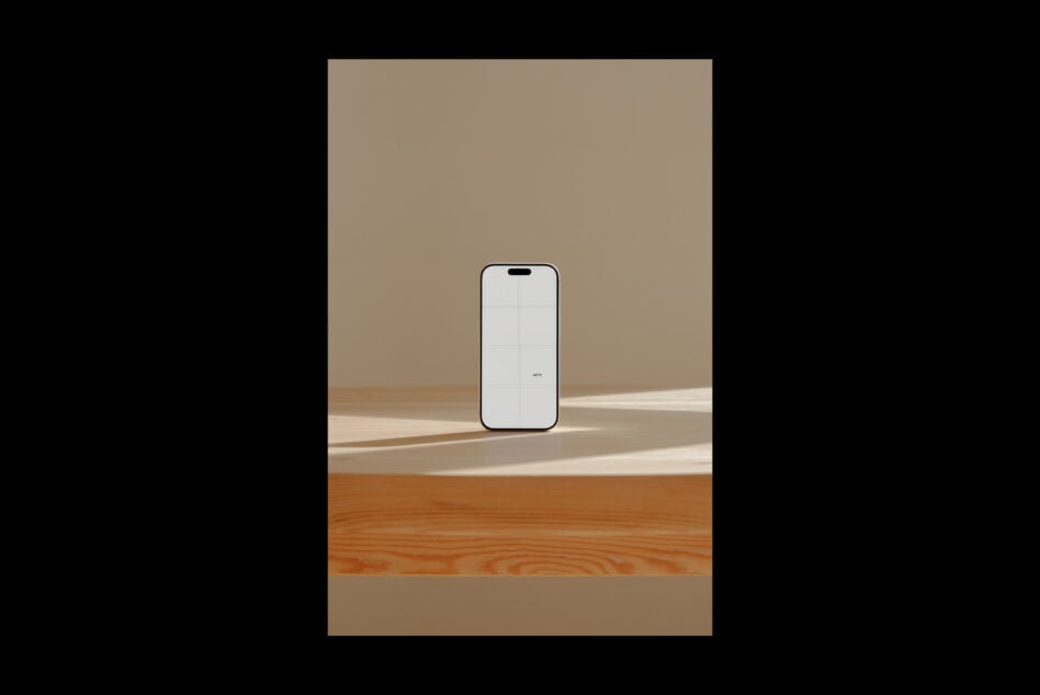 iPhone 14 Pro mockup standing on wooden floor with beige wall, natural light shadows