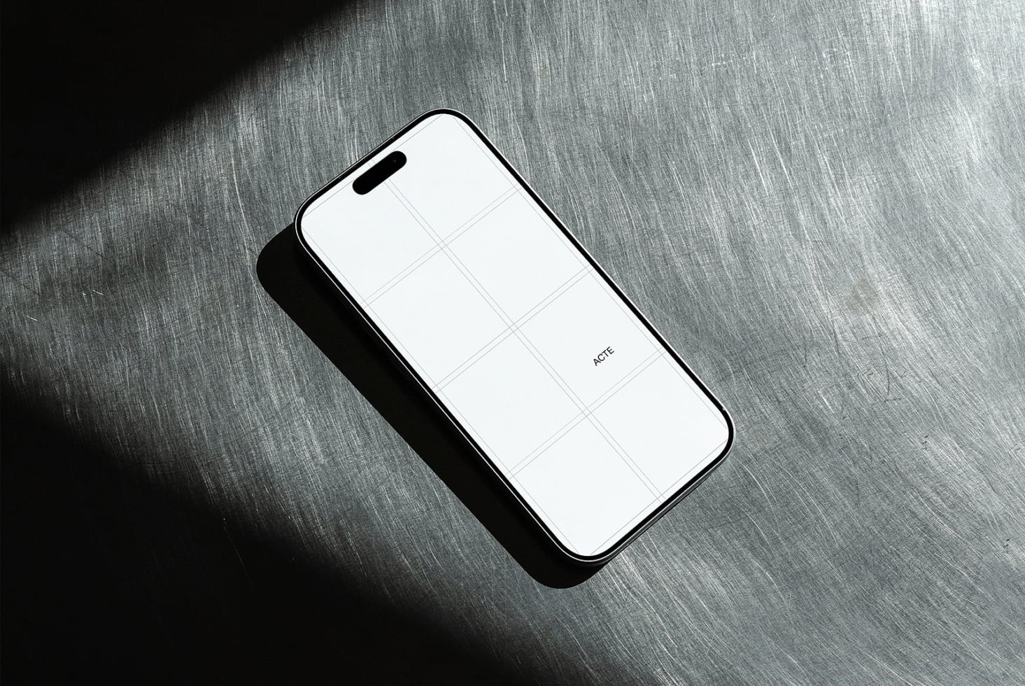 Phone mockup with blank screen on brushed metal surface with dramatic shadow