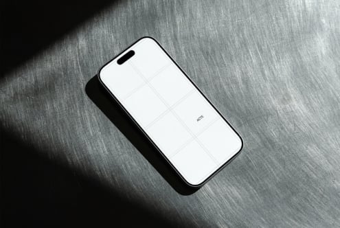 Phone mockup with blank screen on brushed metal surface with dramatic shadow