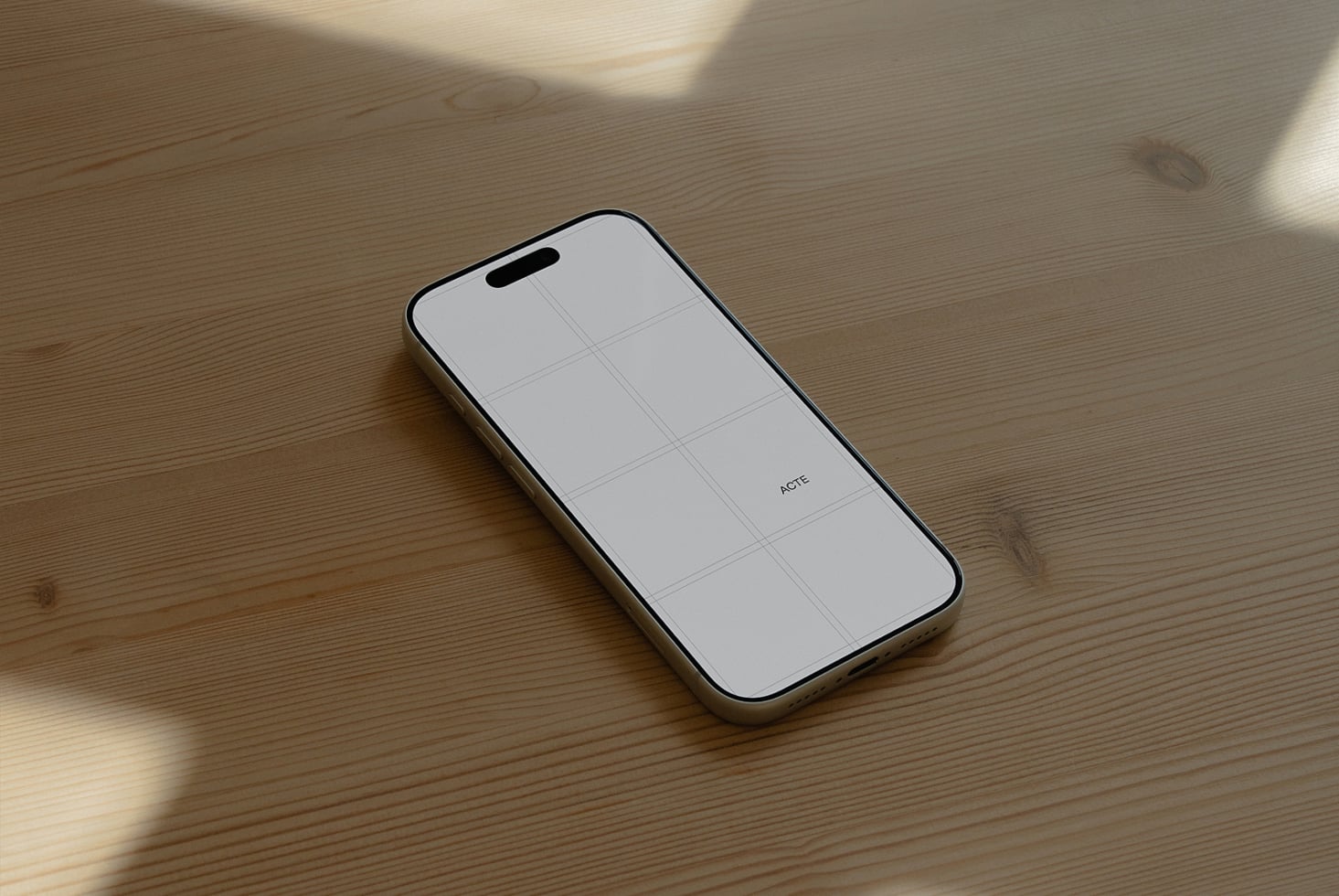 iPhone 14 Pro mockup on wooden surface with grid layout on blank screen