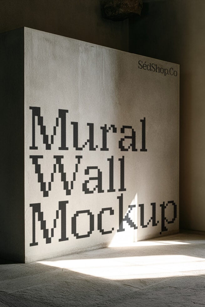 Concrete wall mockup with pixelated typography showing "mutual wall mockup" text in sunlit studio space