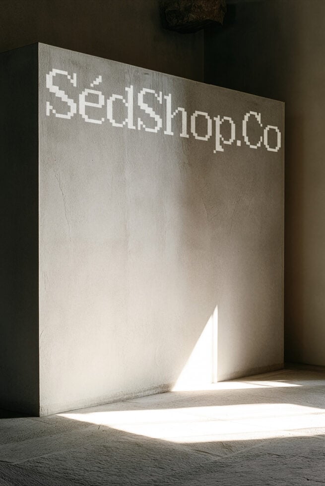 Concrete wall mockup with pixel font text, natural light streaming through opening