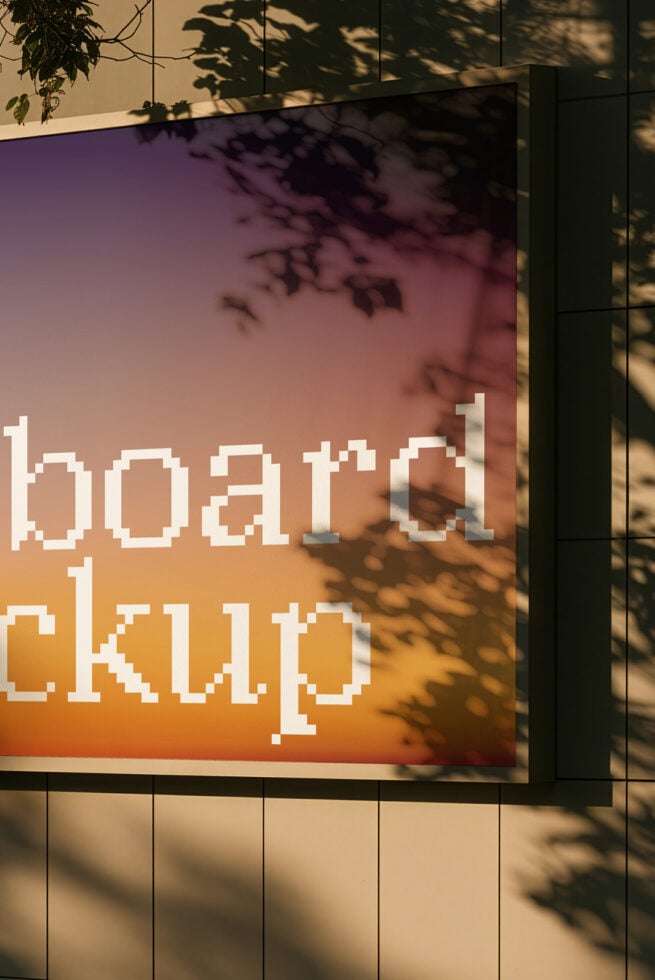 Pixelated retro font on gradient billboard with leaf shadows cast over it