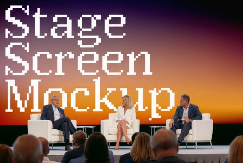 Three panelists on stage during tech conference discussion with pixelated backdrop