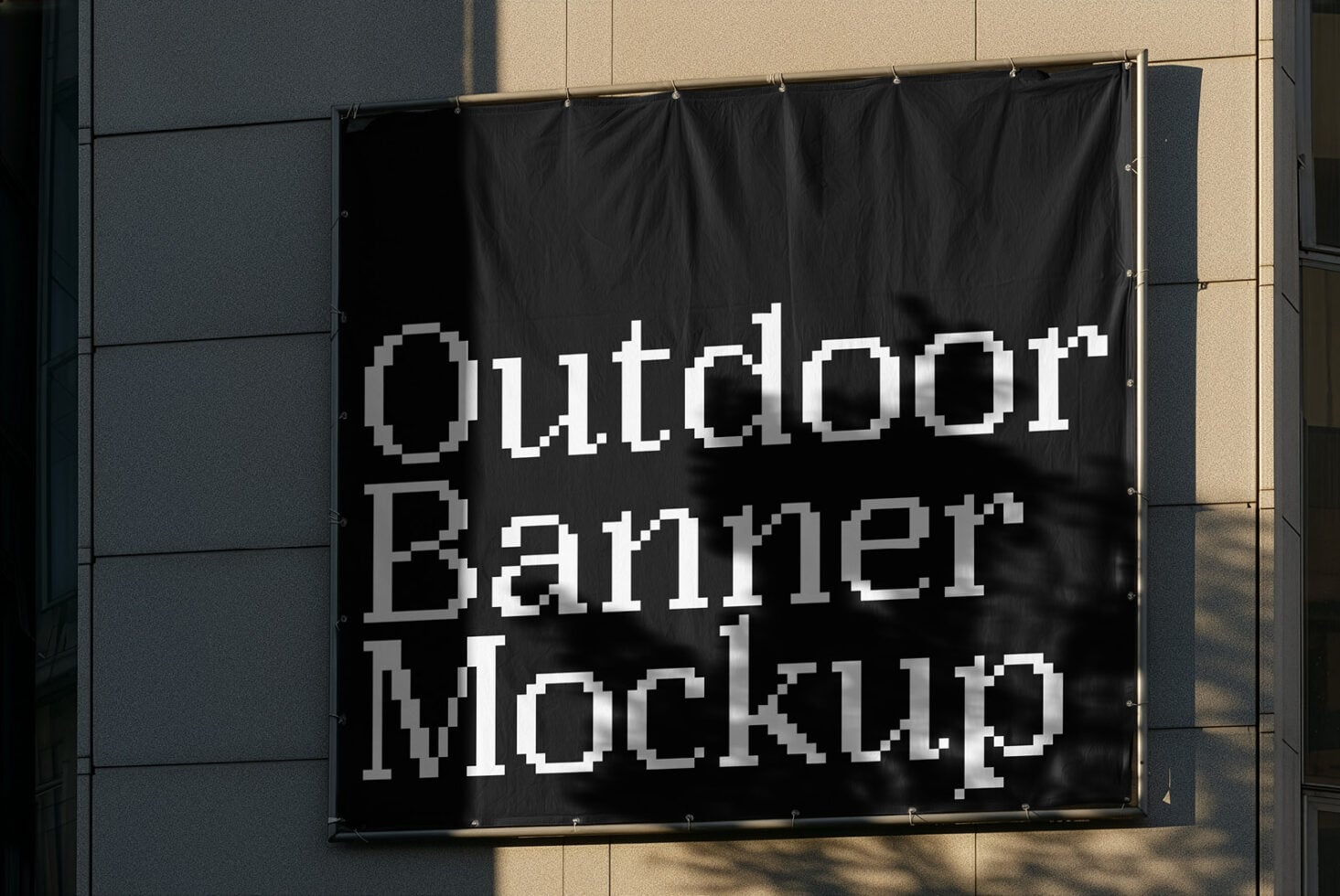 Black fabric banner hanging on modern building facade with pixelated text