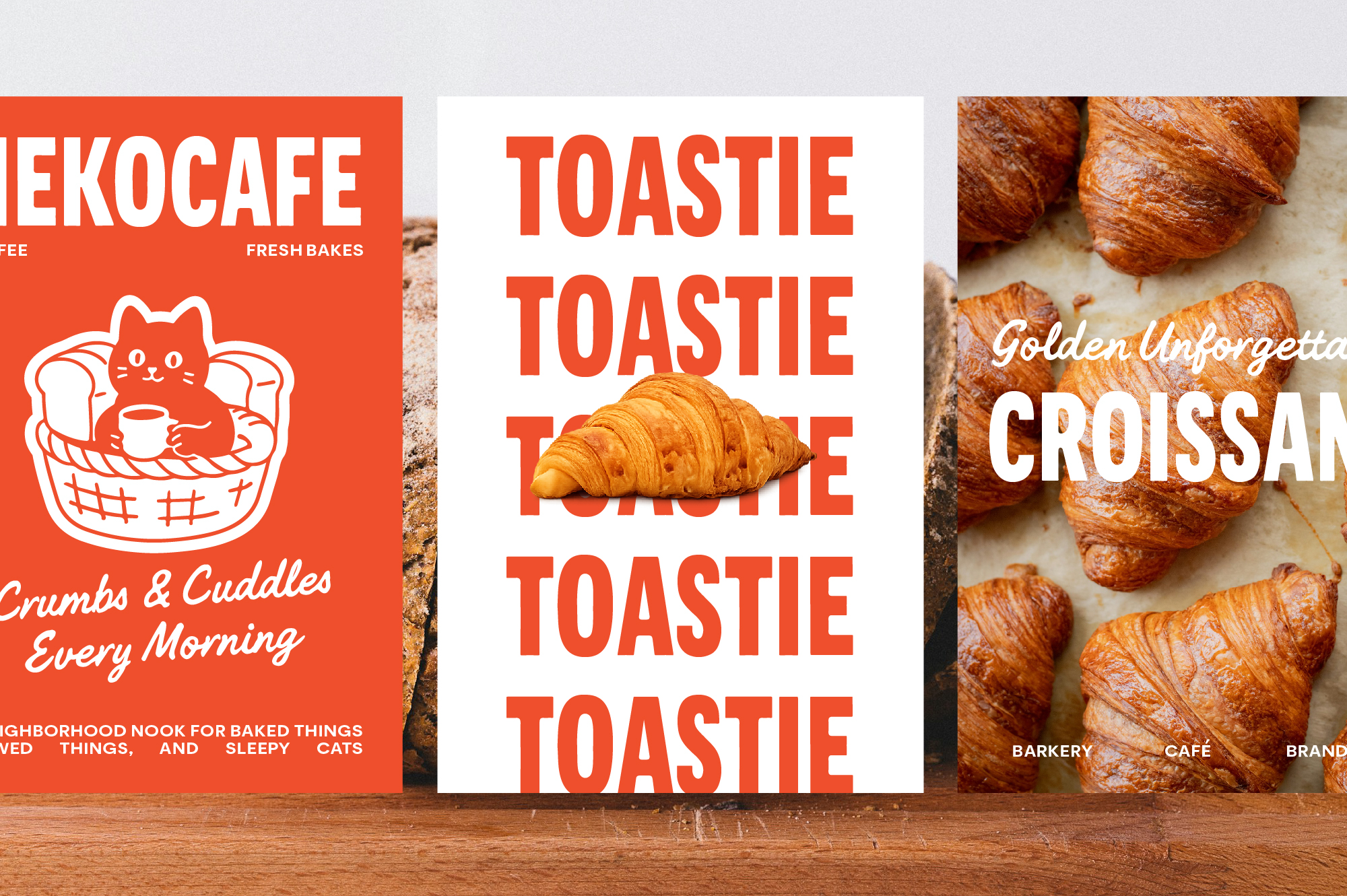 Three bakery posters with bold red text, cute cat illustration, croissant photo mockup on wood