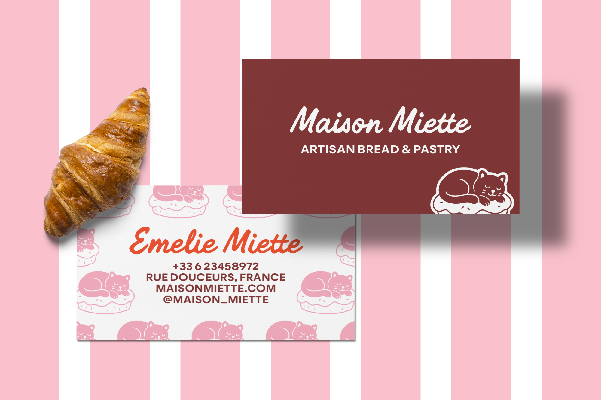Bakery business card mockup with croissant, burgundy branding card, pink cat pattern on striped background