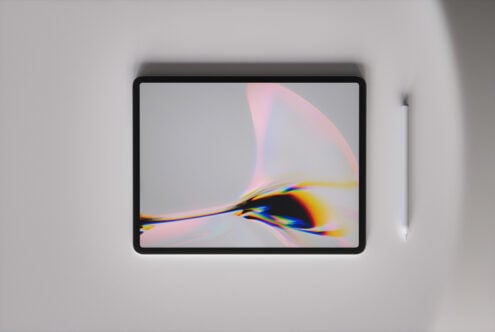 Tablet mockup with stylus showing abstract gradient artwork with pink, yellow, blue light refractions