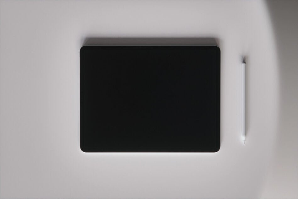 Tablet with stylus on neutral gray surface, overhead shot