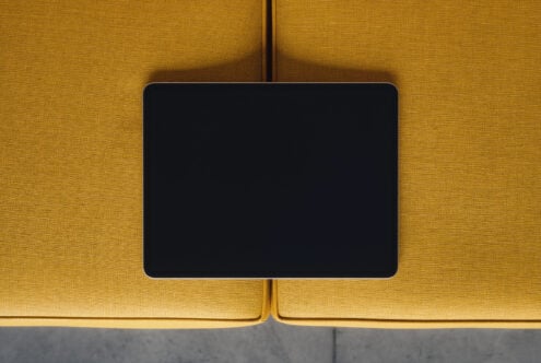 Tablet mockup on mustard yellow fabric with modern minimalist vibe