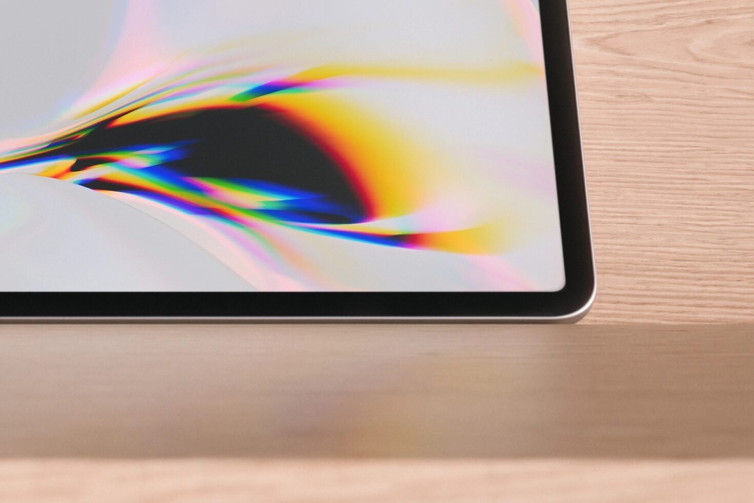 Tablet mockup showing vibrant rainbow light refraction on screen with wood desk backdrop