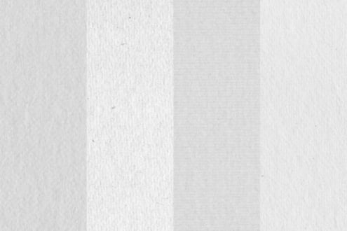 Folded white paper texture with soft shadows showing crease down middle