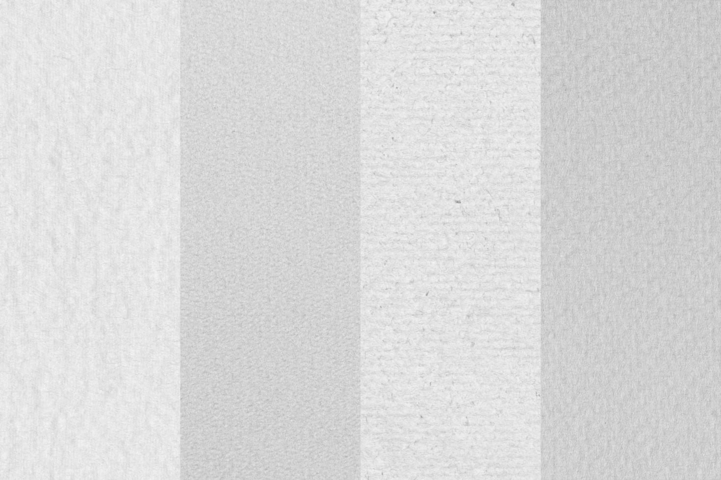 Close-up of recycled paper texture with visible fibers, subtle grain, natural off-white tone