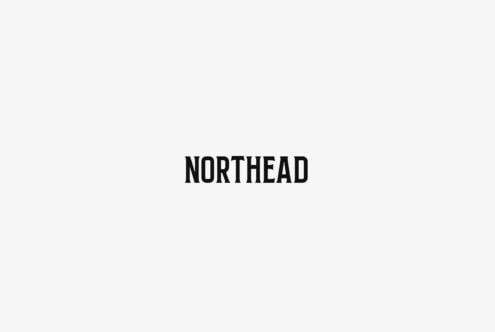 Minimalist beige background with bold black sans-serif text spelling out NORTHEAD in center