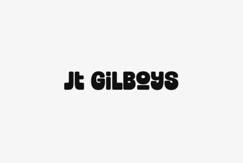 Jt Gilboys chunky black sans serif type on light gray background