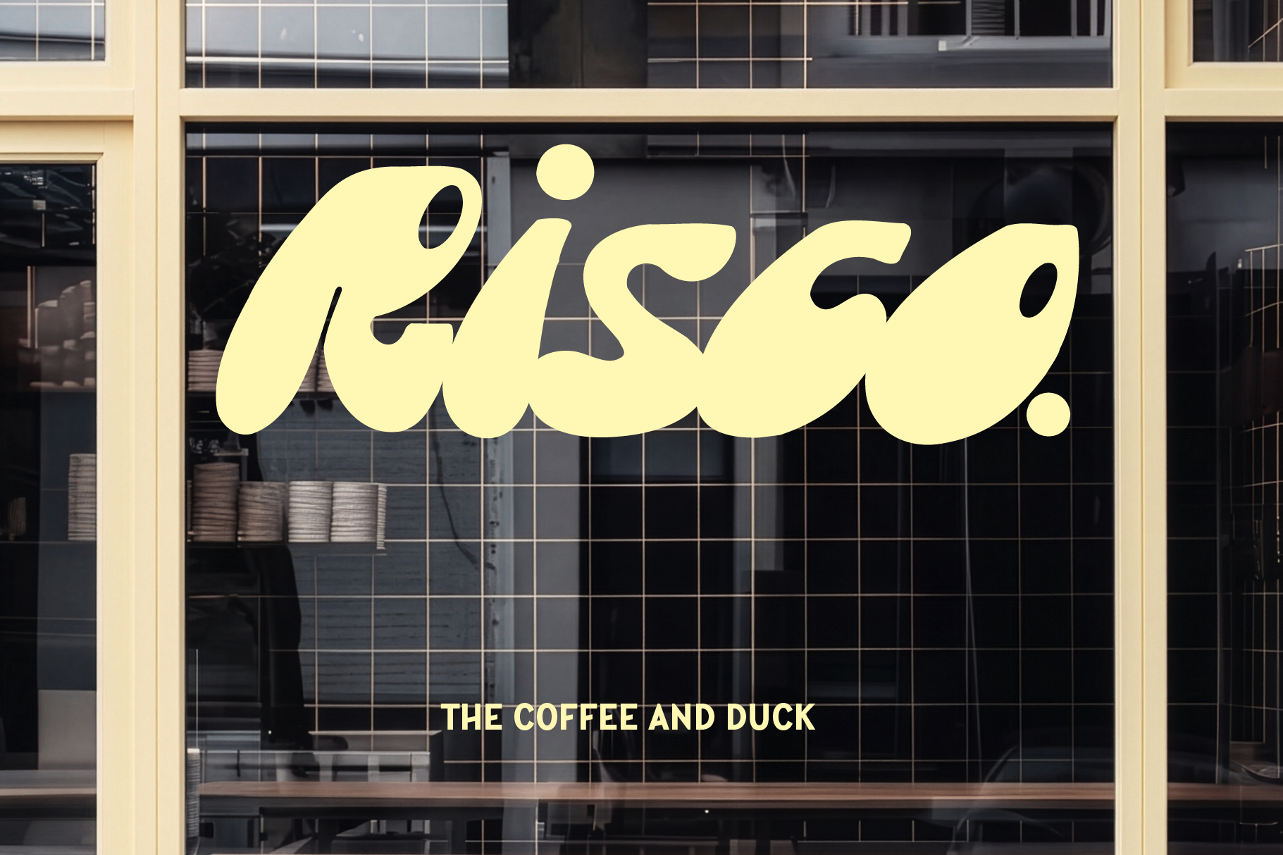 Bright yellow wavy script logo on storefront window with cream frame