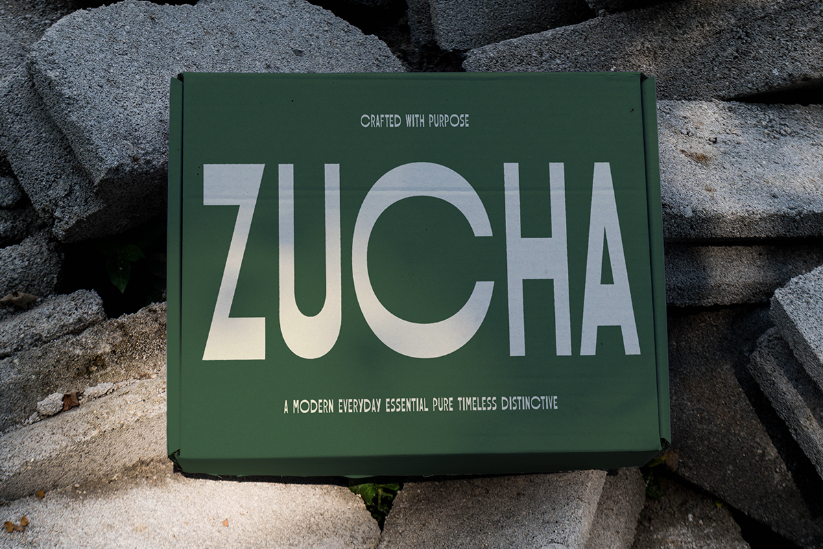 Green box mockup with bold sans serif typography sitting on textured stone surface