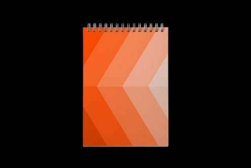 Spiral notebook mockup with orange gradient chevron stripes on black background