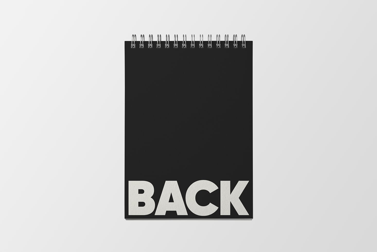 Black spiral notebook mockup showing back cover with blank space for designs
