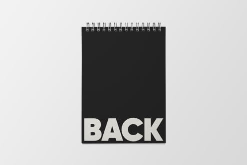 Black spiral notebook mockup showing back cover with blank space for designs
