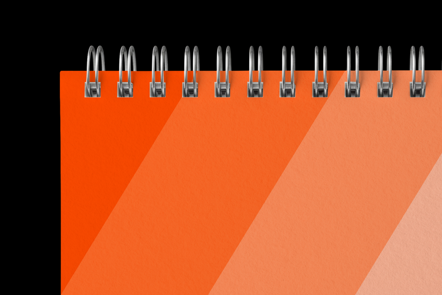 Spiral notebook mockup with metallic binding rings on vibrant orange gradient background