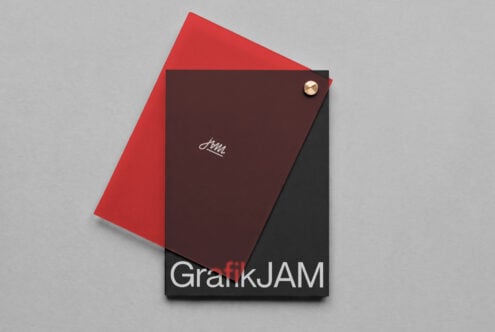Dark burgundy notebook mockup with gold button, red envelope, minimalist branding on gray background