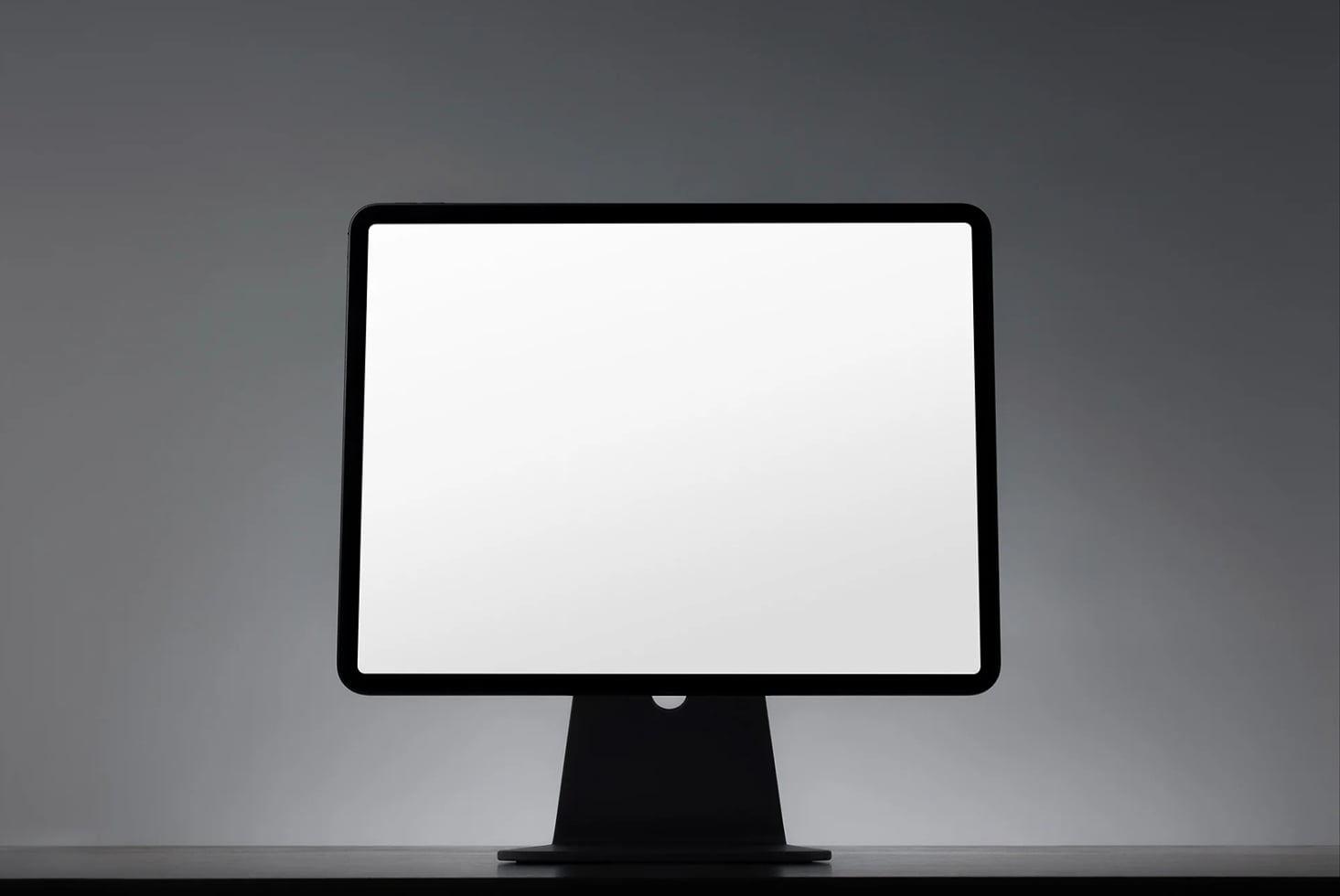 Blank desktop monitor with black bezel on gray background, ready for your design mockup