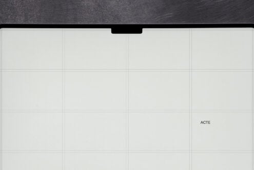 Smartphone mockup with notch, grid layout on cream screen, dark wood texture background