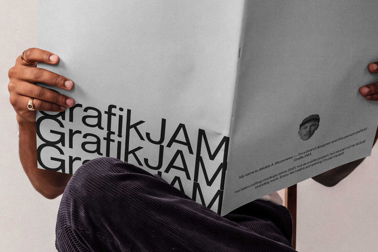 Person holding open magazine mockup with bold black text on white pages